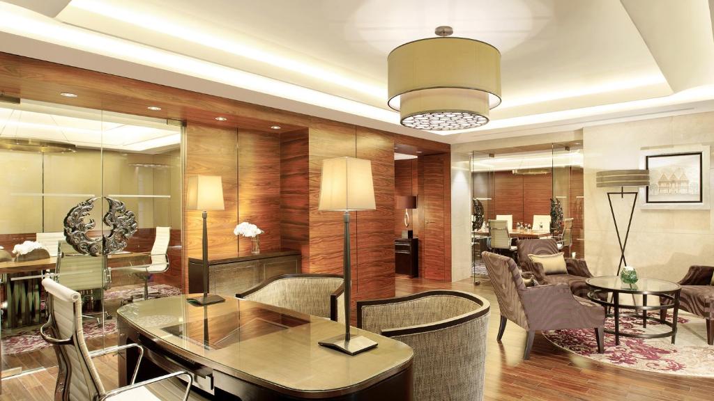 A wood-paneled lounge and meeting area with a broad desk-like table.