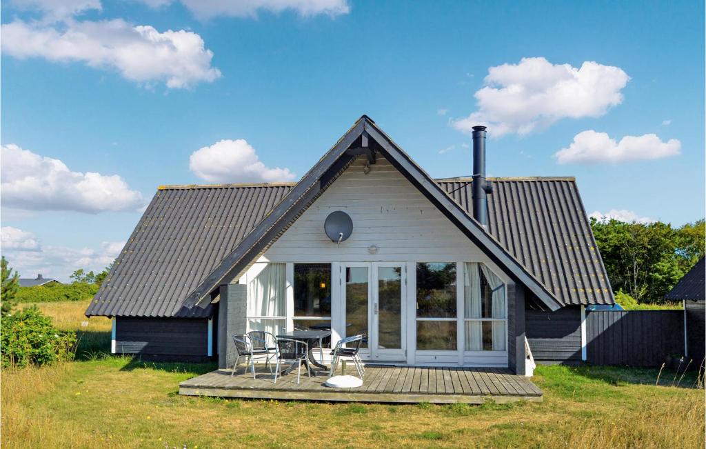 a small house with a porch and a deck at Holiday Home Slettevej Ii in Skagen