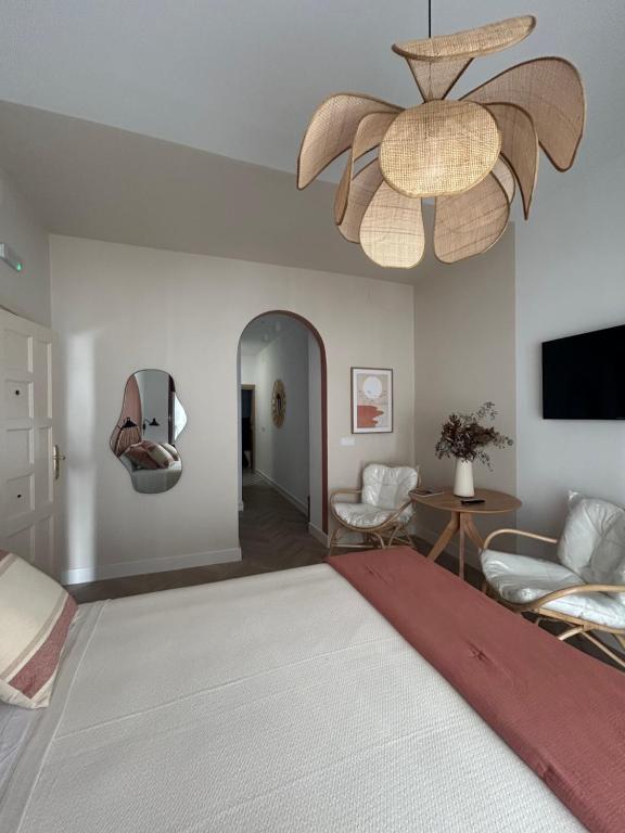 a bedroom with a large bed with a ceiling fan at Sol de Zafra Estudio in Zafra