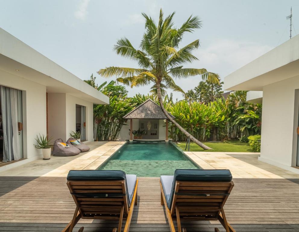 a swimming pool in the middle of a villa at Exclusive 4BR Tranquil Sanctuary in Pererenan in Canggu
