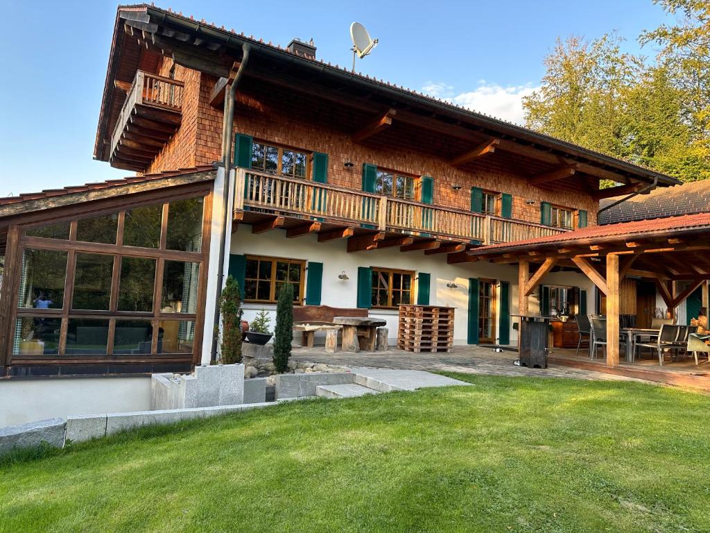 a large wooden house with a lawn in front of it at Zwieslerwaldhaus4 in Lindberg