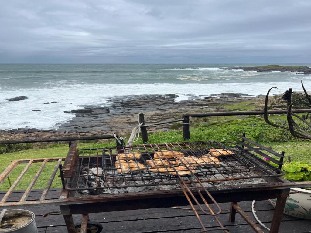 a grill with food on it on the beach at Mazeppa Sunrise Beach Accommodation in Mazeppa Bay