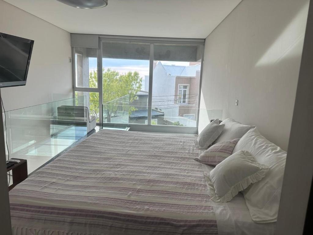 En eller flere senge i et værelse på Ayres Puerto Madryn