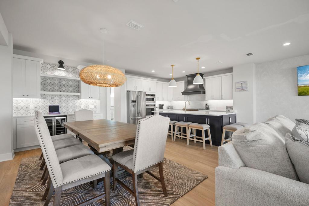 a kitchen and living room with a wooden table and chairs at Surfview Paradise Manor in Palm Coast