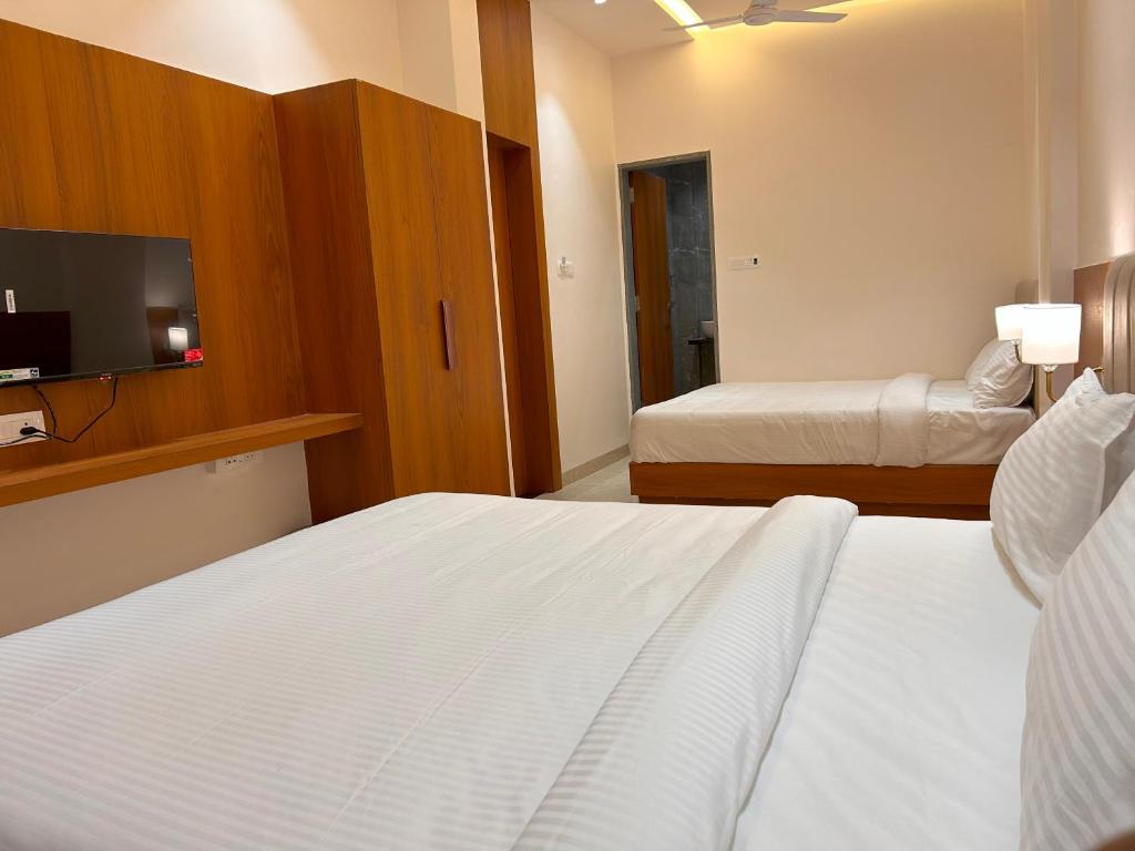 Postel nebo postele na pokoji v ubytování Hotel Neem Heritage