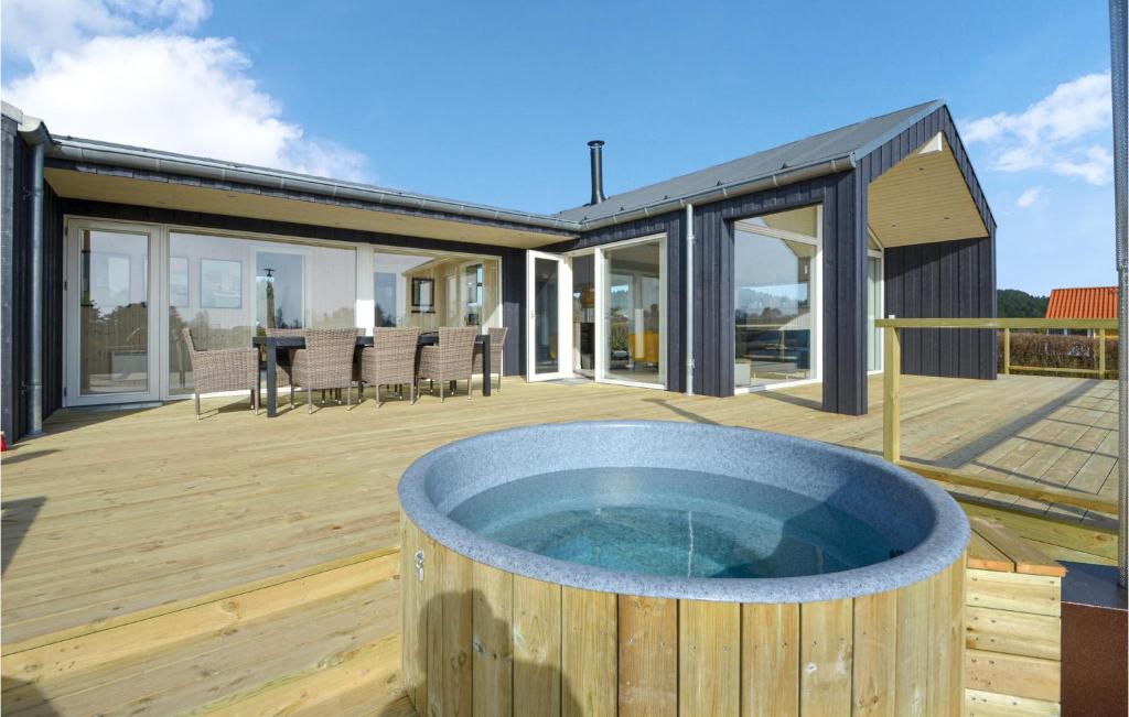 a hot tub on the deck of a house at Holiday Home Ebeltoft With A Fireplace 9 in Ebeltoft