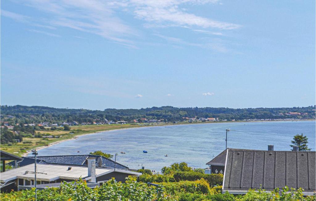 a view of a body of water with a beach at Holiday Home Sardinvej With Fireplace And Shower in Ebeltoft