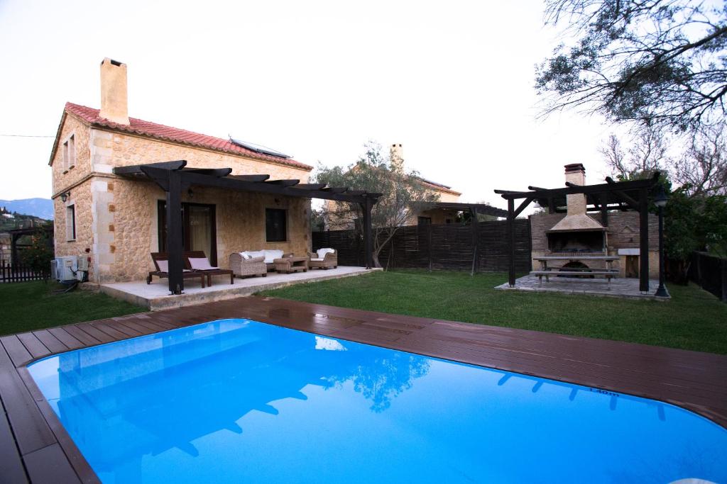 a large swimming pool in front of a house at 5 Stars Villas in Svoronata