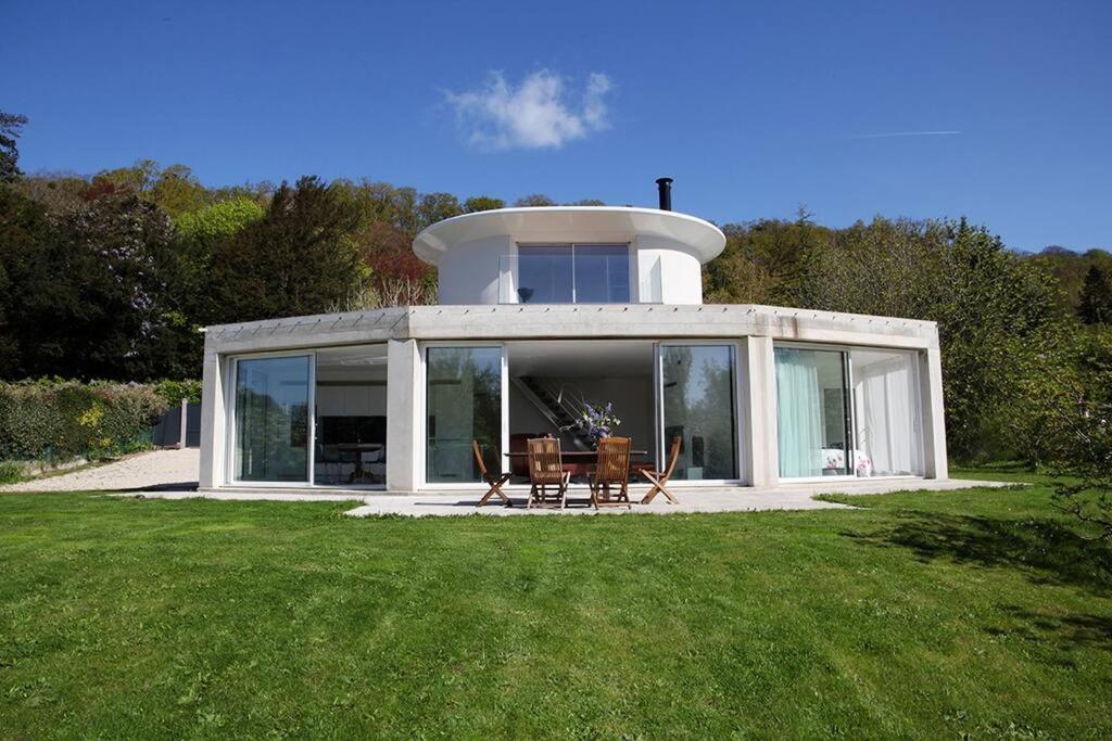 a house with a round building with a lawn at Port Saint Jean - Maison de Designer in Saint-Jean-le-Thomas
