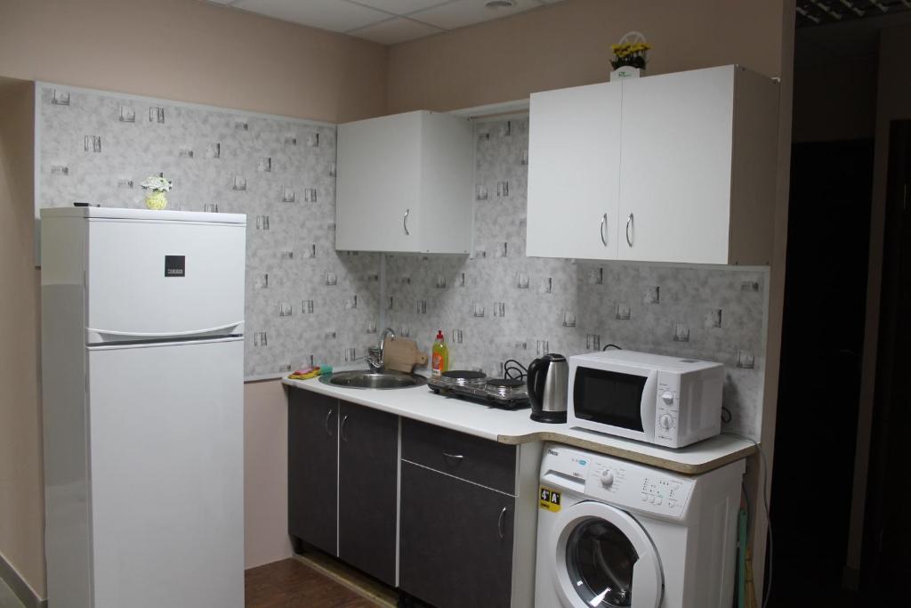a kitchen with a white refrigerator and a washer at Best4Rest in Kyiv