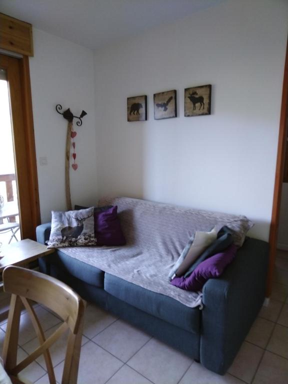 Ce lit se trouve dans un dortoir doté d'oreillers violets. dans l'établissement Appartement montagne, à Vars