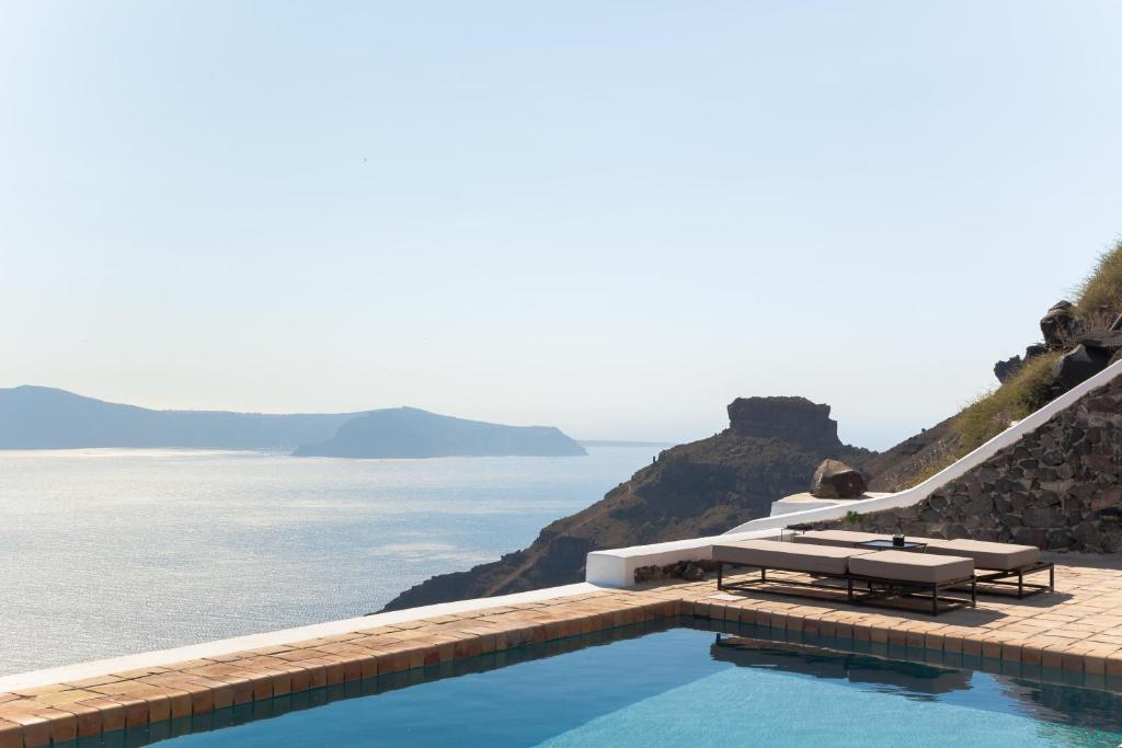 a swimming pool with a view of the ocean at The Vasilicos in Imerovigli