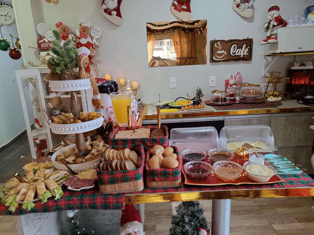 a table topped with lots of different types of food at Pôr-do-Sol Pousada in Penha