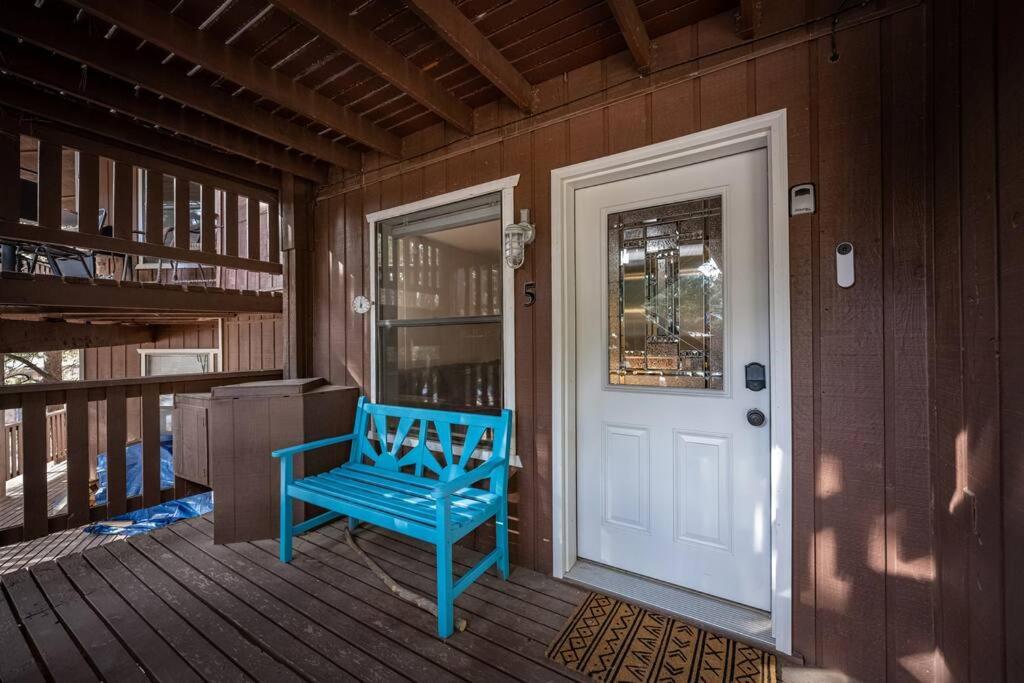 a blue bench sitting on the front porch of a house at Skyes Hideaway Walk to Lifts in Angel Fire