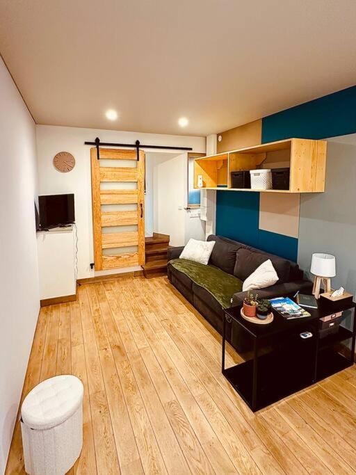 un salon avec un canapé et une table dans l'établissement Studio Le Franc Bourgeois, à Sedan