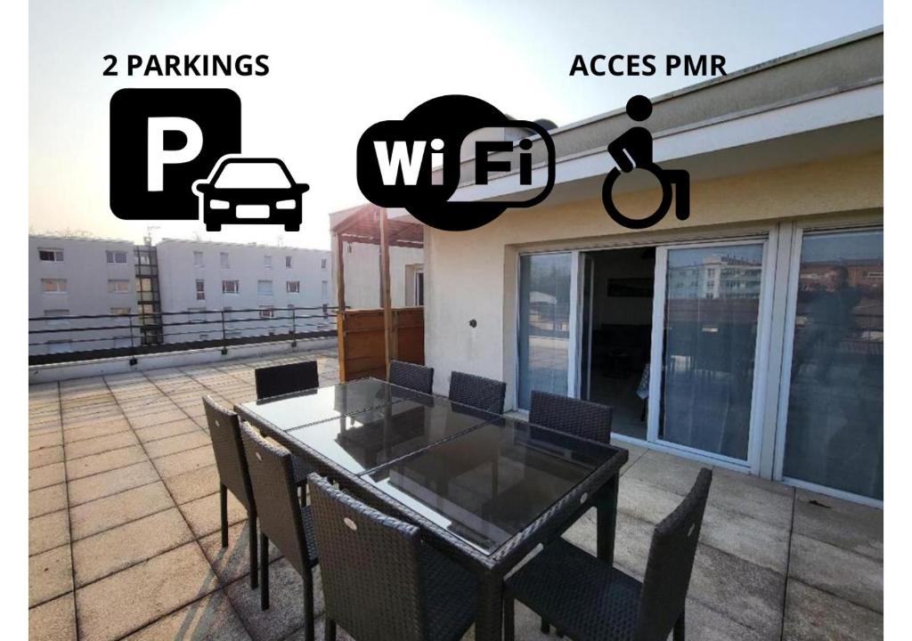 a dining table and chairs on a balcony with a car outside at ROOFTOP 3 CHAMBRES, TERRASSE, GARAGE in Vénissieux