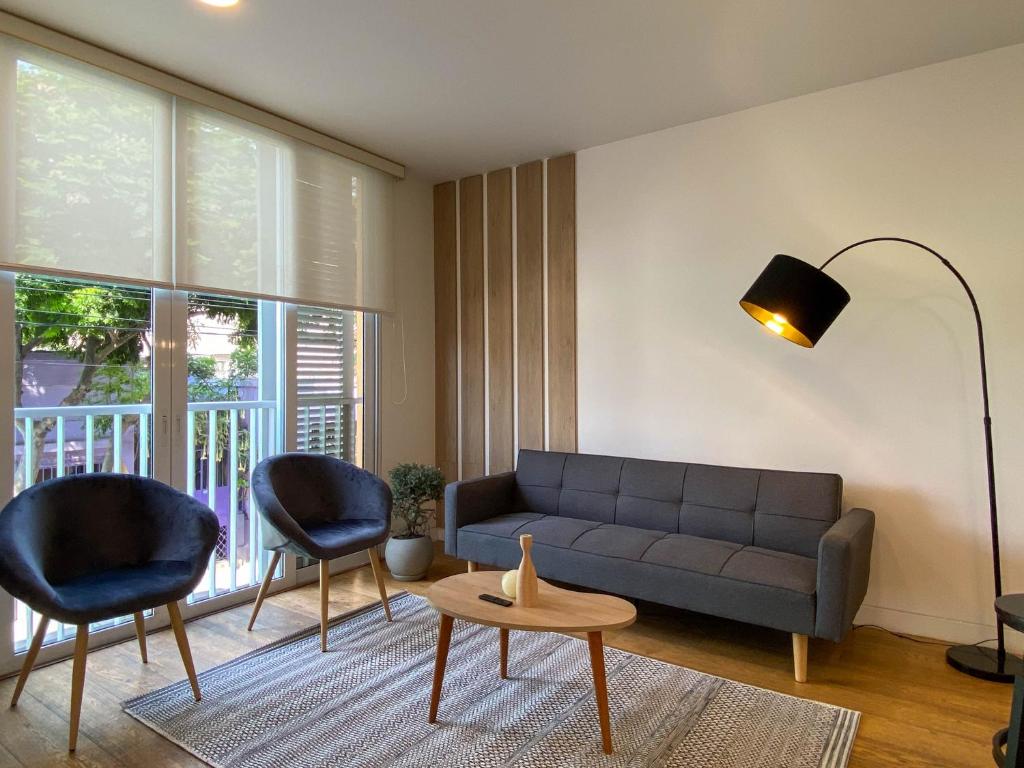 a living room with a couch and two chairs at Duplex with Balcony in Barranco in Lima