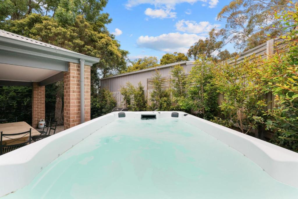 a swimming pool in the backyard of a house at Cowes Sunset Retreat in Cowes