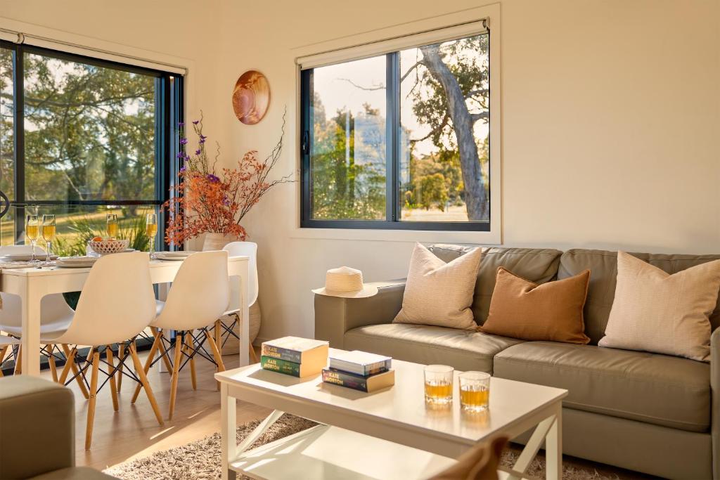 a living room with a couch and a table at Gumleaf in Coles Bay
