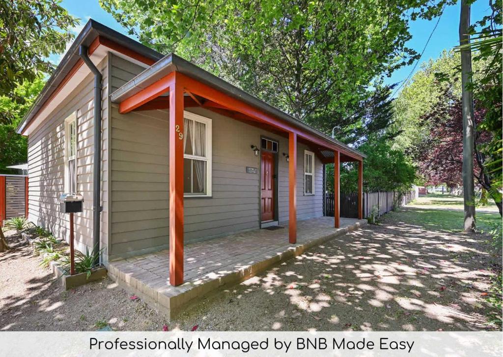 una pequeña casa con techo naranja en Greenwood Cottage - Close to CBD, Leafy Backyard, en Bathurst