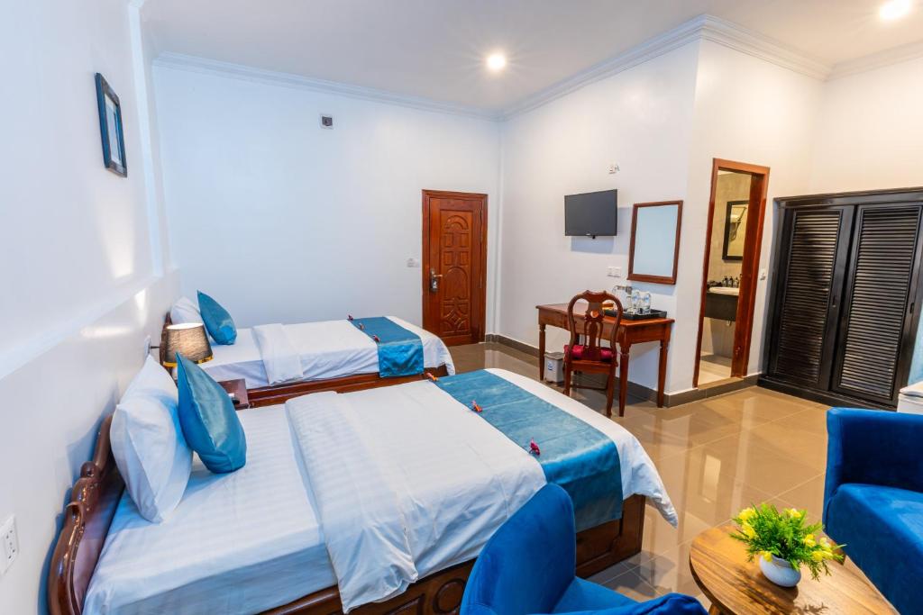 Postel nebo postele na pokoji v ubytování Rithy Rin Angkor Hotel