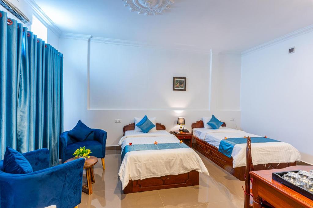 Postel nebo postele na pokoji v ubytování Rithy Rin Angkor Hotel