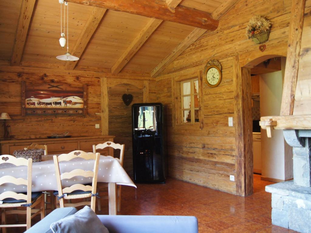 d'une salle à manger avec une table et un réfrigérateur noir. dans l'établissement Charmant appartement près des pistes, parking inclus - FR-1-467-138, au Grand-Bornand