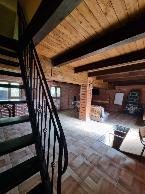 a large room with a staircase in a house at Vila SCARLET Pielesti Dolj in Cîmpeni