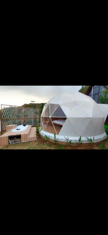 a white tent sitting on top of a field at Kusumanagara Dome1 in Panjadakan