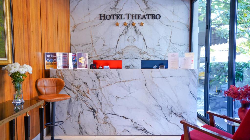 a lobby with a marble counter with a hotel teracio sign at Hotel Theatro- City Center in Tirana