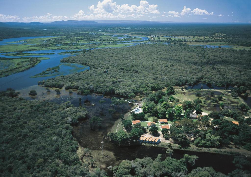 an aerial view of a house next to a river at Pousada Do Rio Mutum in Barao de Melgaco