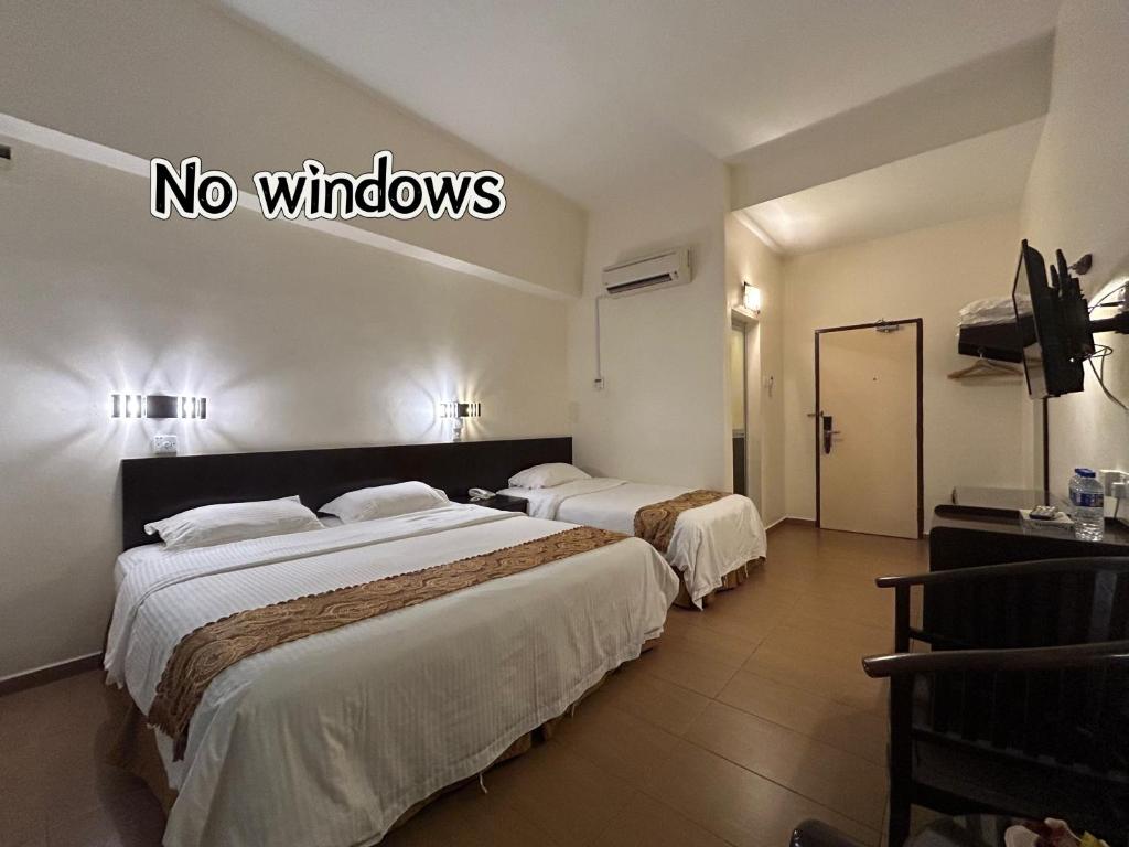 Postel nebo postele na pokoji v ubytování Pontian Garden Hotel