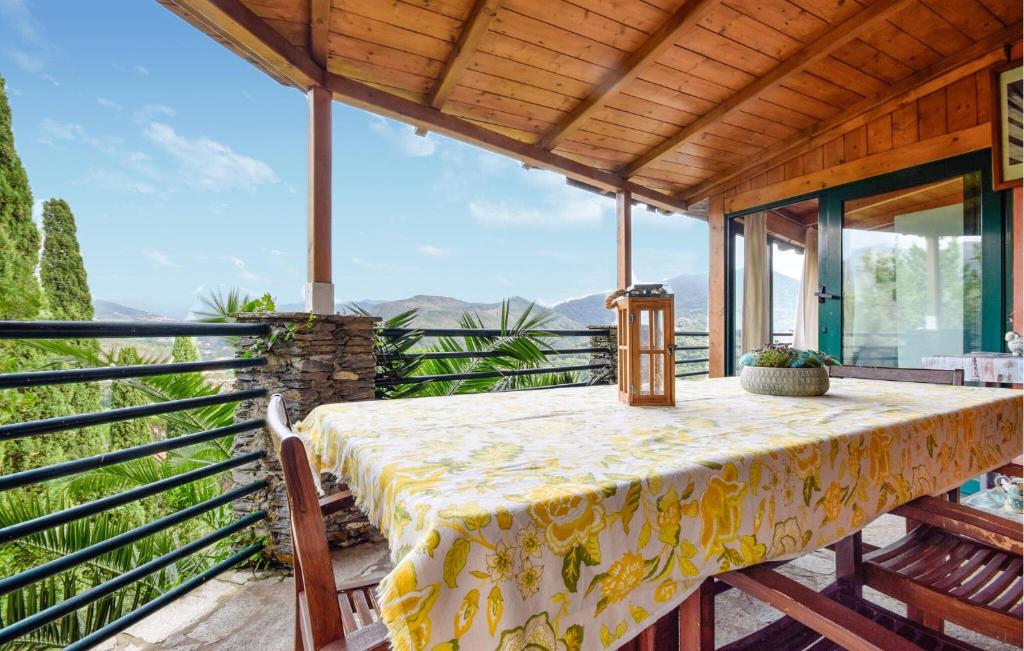 a table on a balcony with a view of the mountains at Awesome Apartment In Casarza Ligure in Casarza Ligure