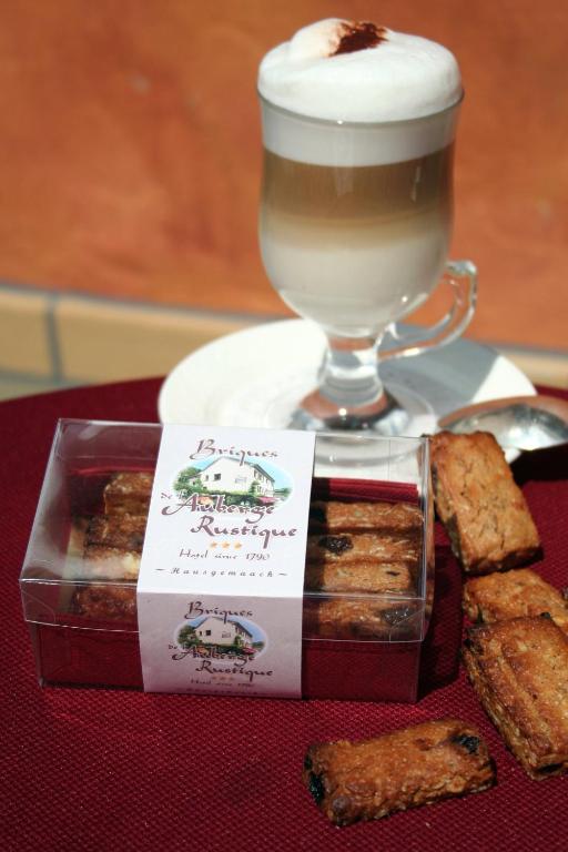 a tray with a cup of hot chocolate and some pastries at Hotel Auberge Rustique in Beaufort