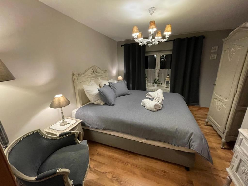 a bedroom with a bed with a stuffed animal on it at El Bre du Faubourg in Walcourt