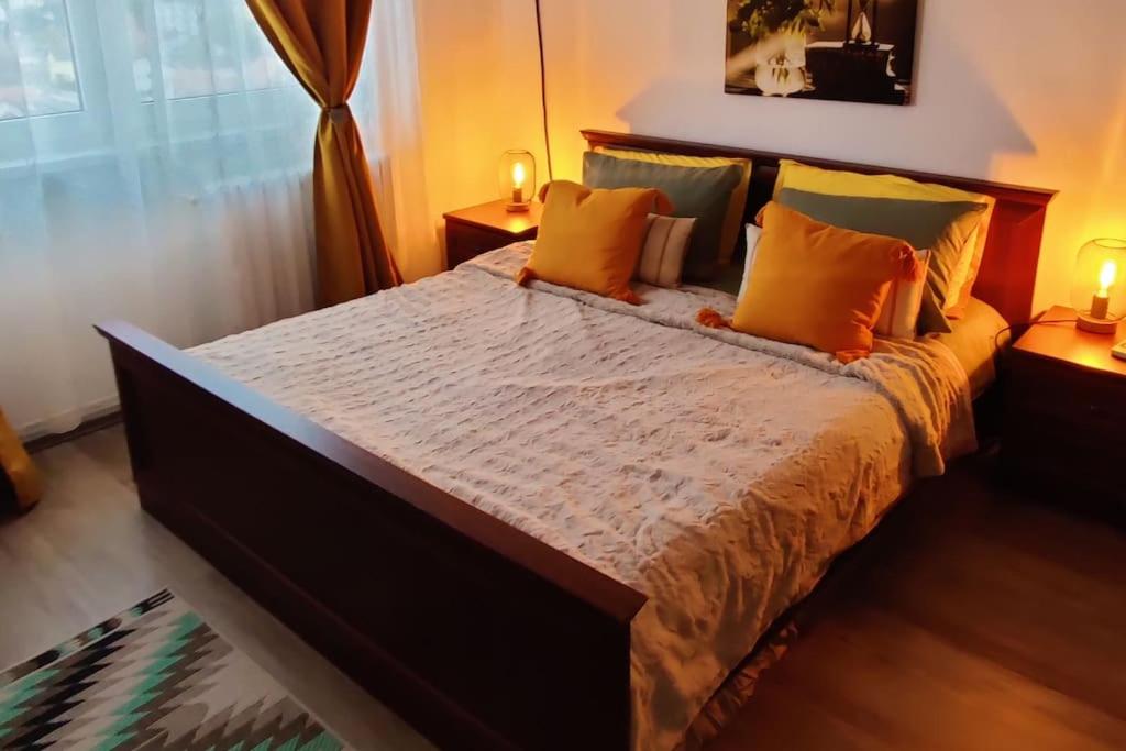 a bedroom with a large bed with orange pillows at FLH - The Happy Nest - a child-friendly apartment in Sibiu