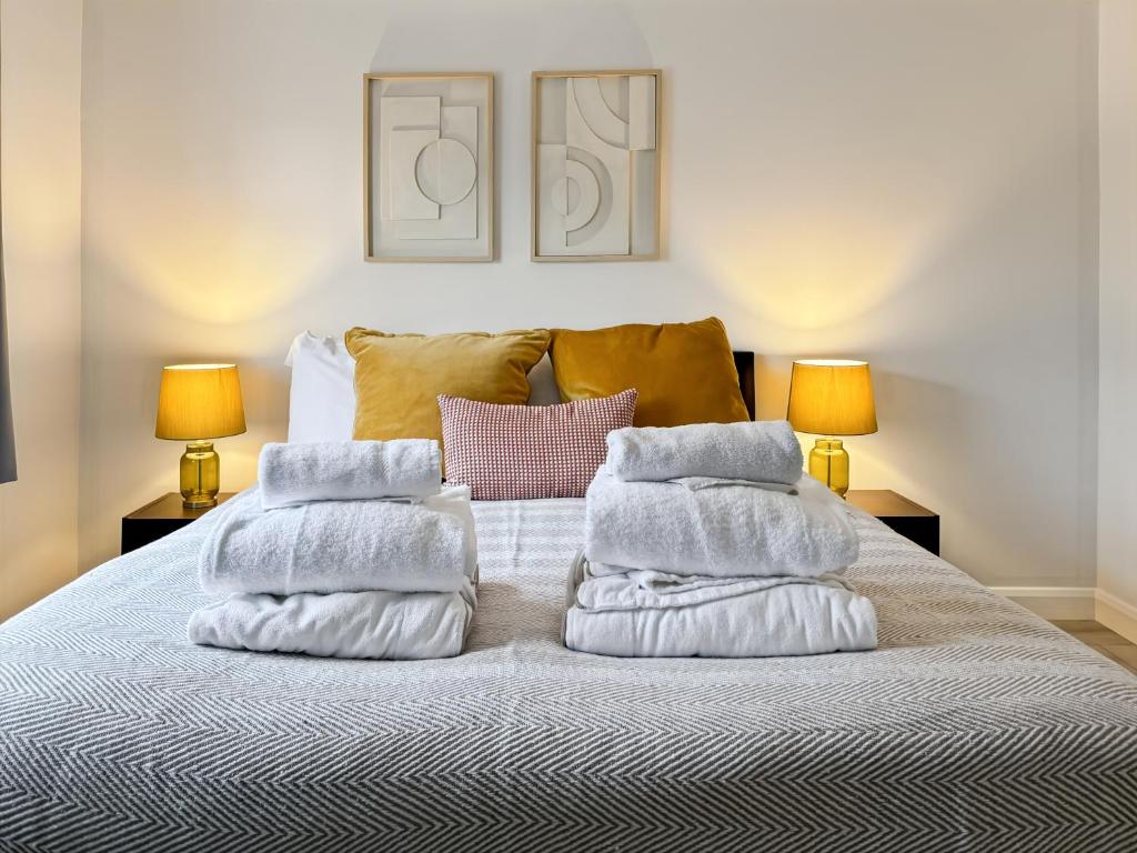 une pile de serviettes posée sur un lit dans l'établissement Cozy Hideaway With Hot Tub Sauna Sleeps 7, à Falmer