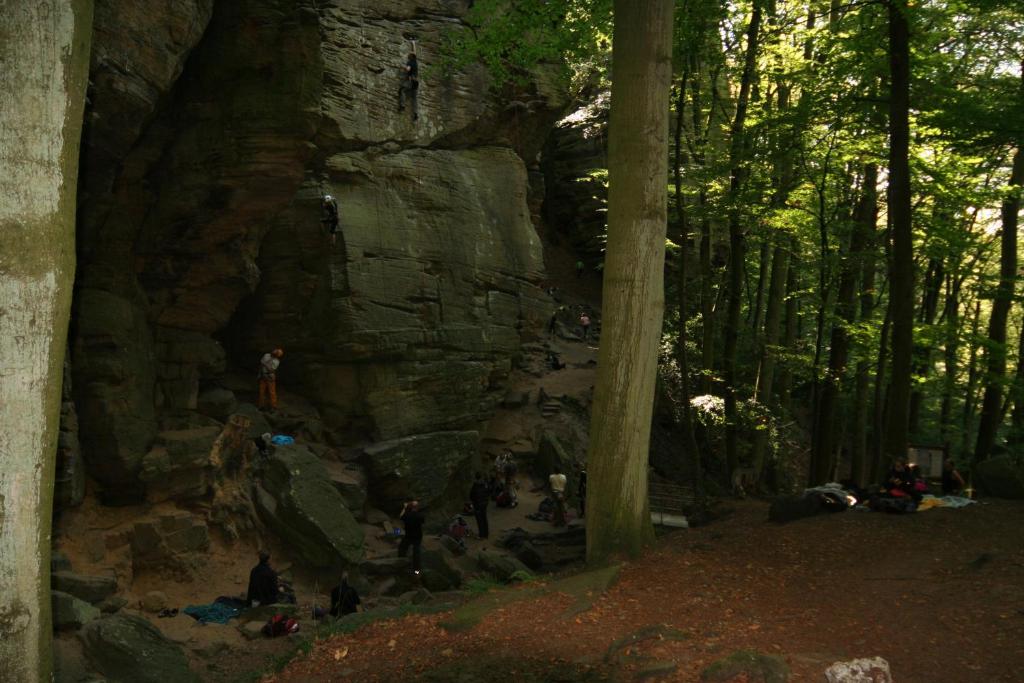 a group of people standing around a large rock formation at Hotel Auberge Rustique in Beaufort