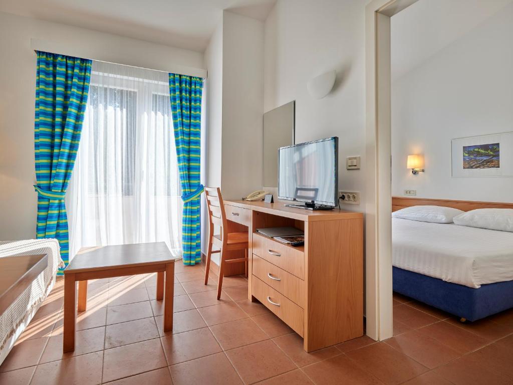 Postel nebo postele na pokoji v ubytování Koversada Apartments Naturist Park