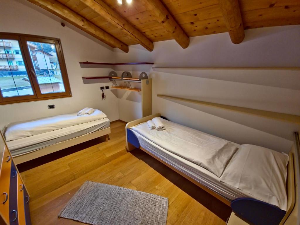 Voodi või voodid majutusasutuse Chalet Larsech by AMA Val di Fassa toas