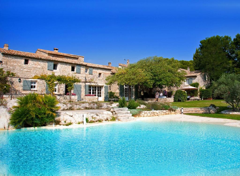 a large swimming pool in front of a house at Le Mas De La Rose - Teritoria in Orgon