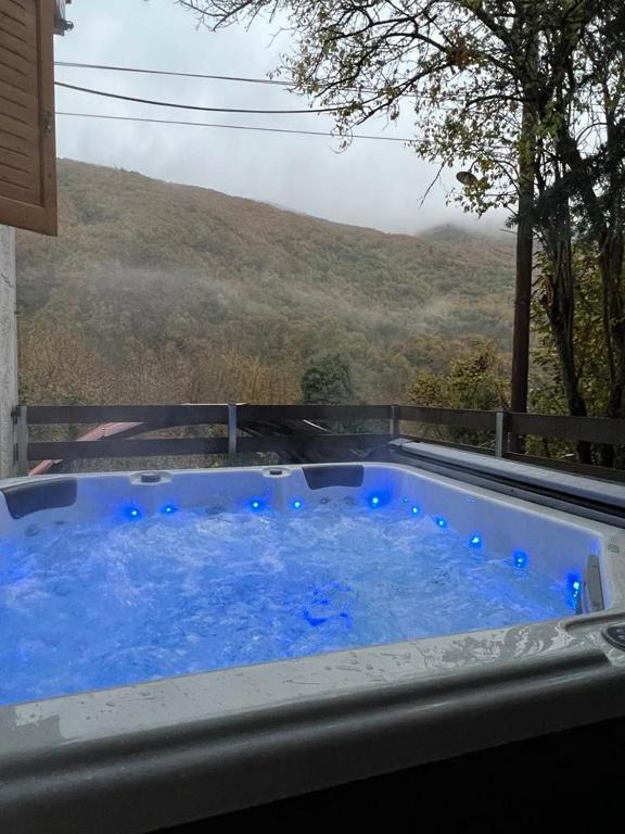 a hot tub with a view of a mountain at Forest view Aggeliki in Karpenisi