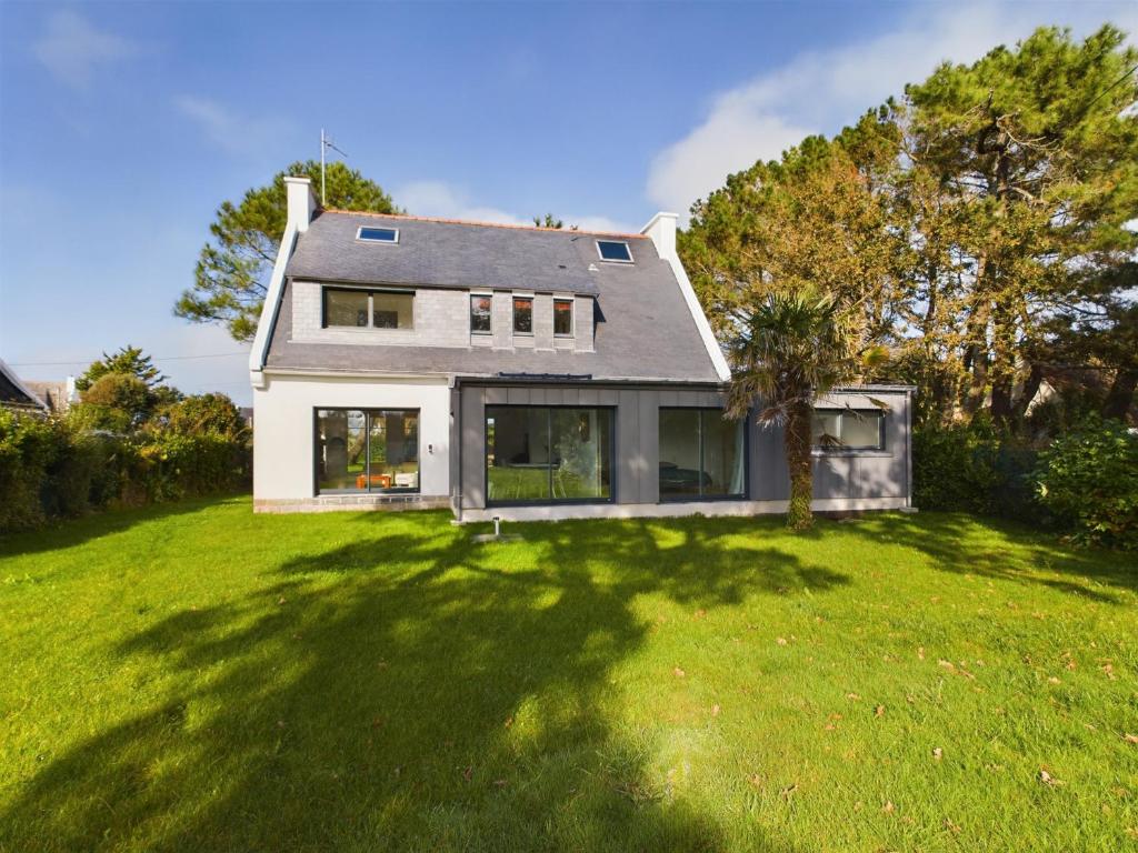 une maison avec une grande cour avec de l'herbe verte dans l'établissement -OZARIO- Magnifique maison au Cabellou, à Concarneau