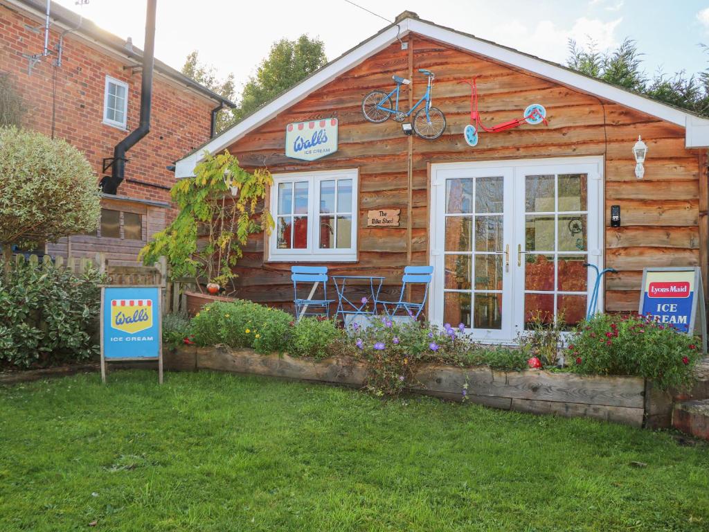 a log cabin with a bike on top of it at The Bike Shed in Romsey