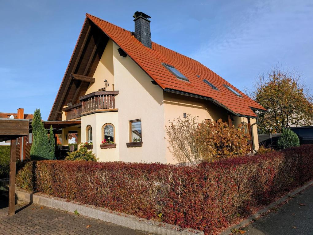 a house with an orange roof on a street at Schöne 2-Raumwohnung inklusive Infrarot-Wärmekabine in Großröhrsdorf