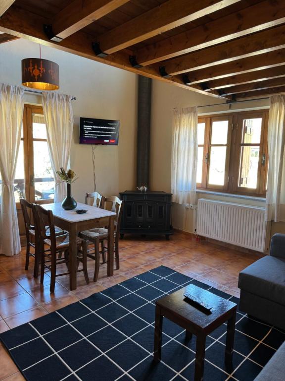 a living room with a table and a couch at Frigias 2 in Arachova