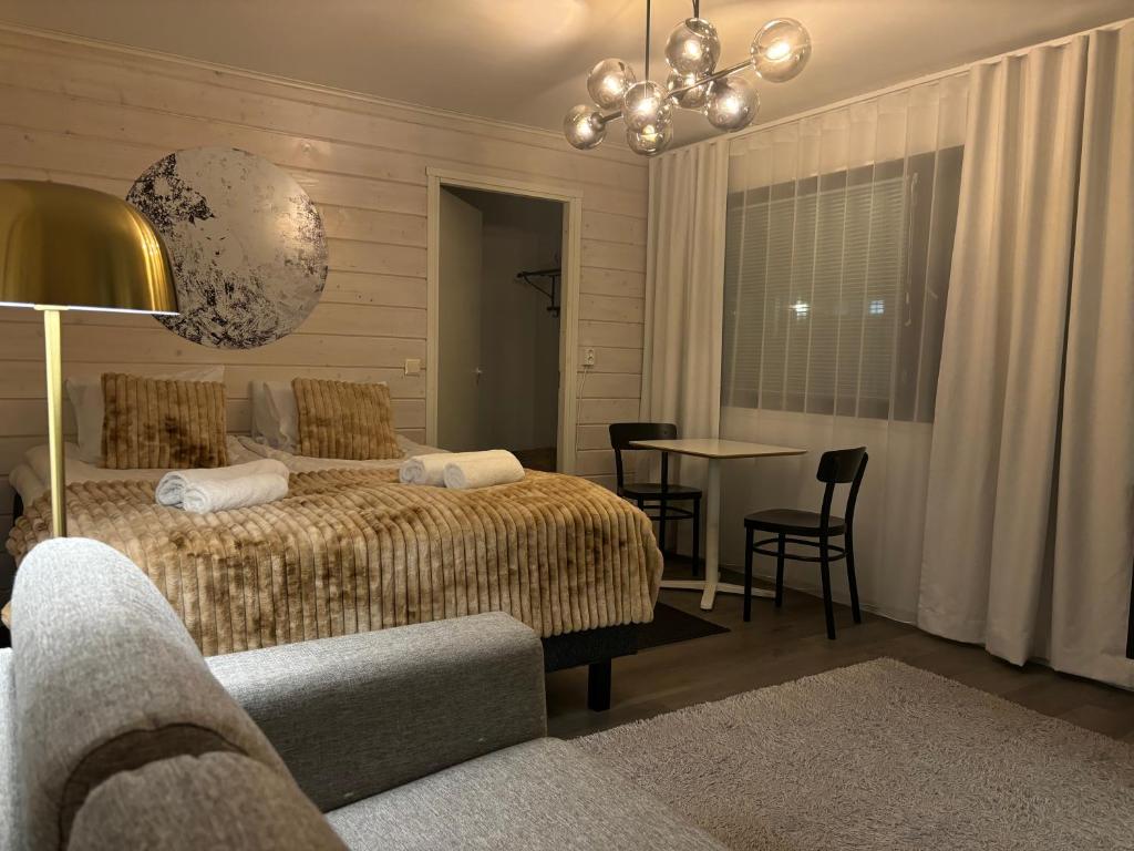 a bedroom with a bed and a table and chairs at Arctic Cozy Apartment in Rovaniemi