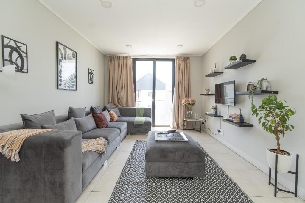 a living room with a couch and a table at Casa Bella in Summerstrand