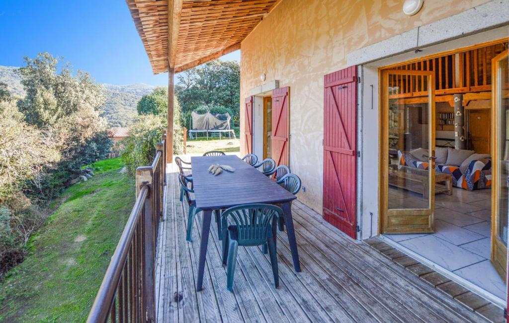 a wooden deck with a table and chairs on it at 4 Bedroom Lovely Home In Azilone Ampaza in Azilone-Ampaza