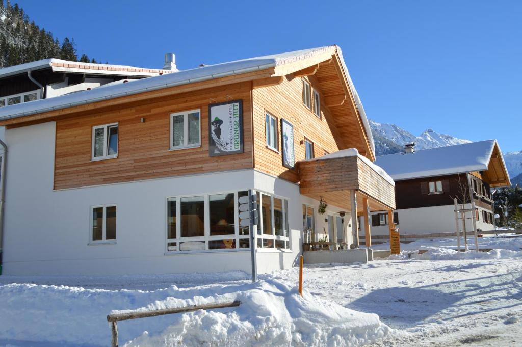 a house in the snow in front at Bergsteiger-Hotel "Grüner Hut" in Bad Hindelang